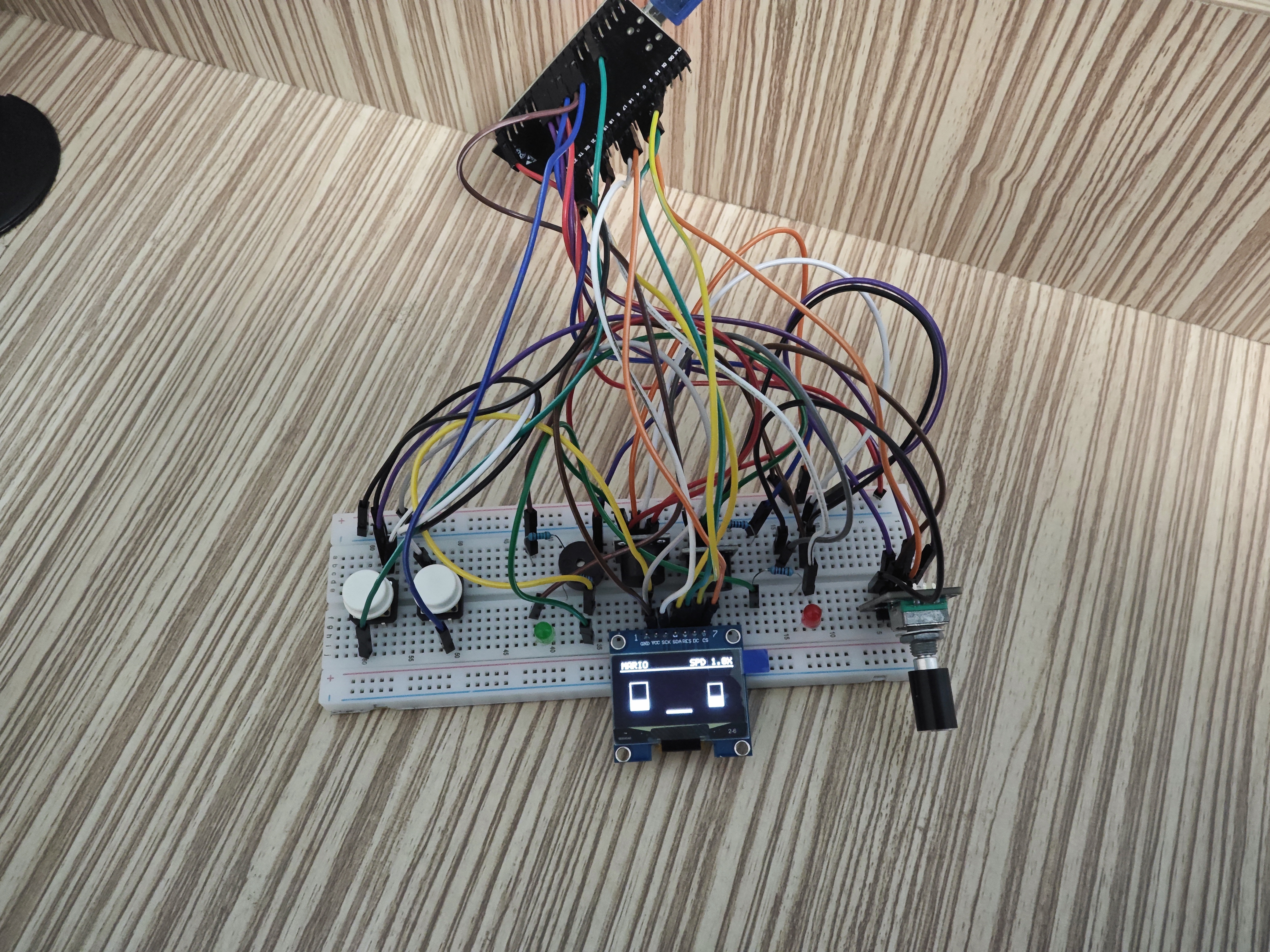 Close-up of the rotary encoder, tactile buttons, LEDs, and three buzzers